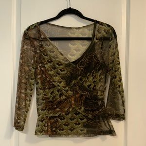 Woman’s rich earth tone, see through top with  matching cami.